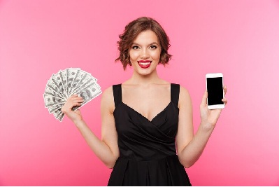 Image of a girl showing money with phone