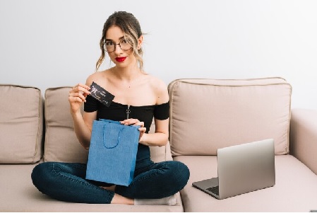 a women with credit card and shopping bag to save money